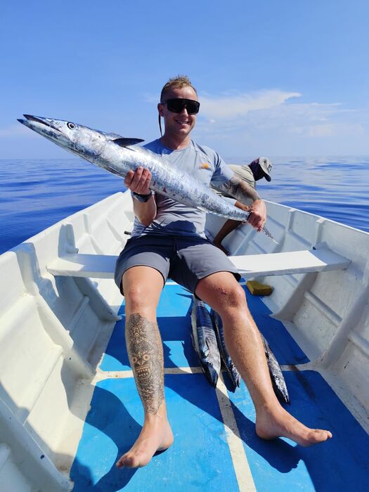 Guest holding a wahoo caught near Gili Air